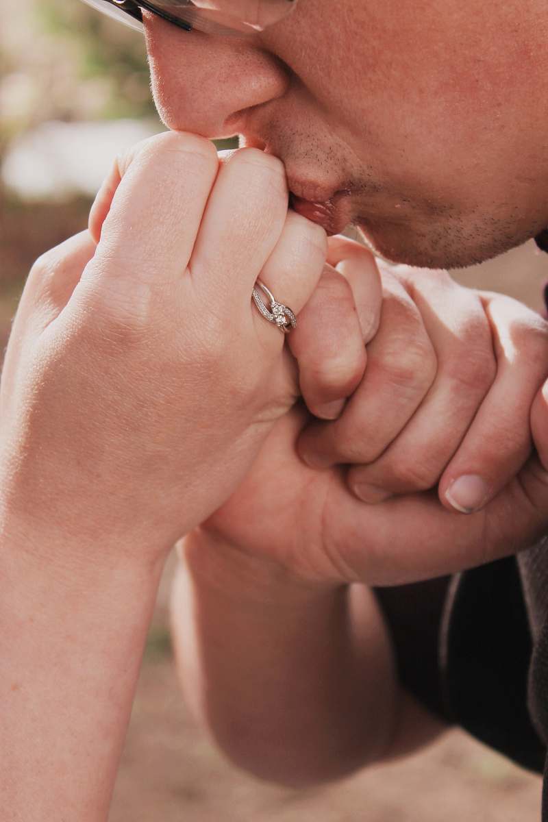 holding hands closed up photo of person kissing hand couple